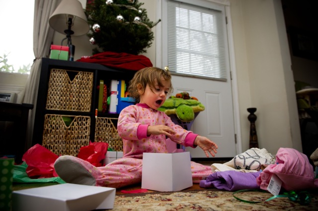 toddler opening presents christmas morning