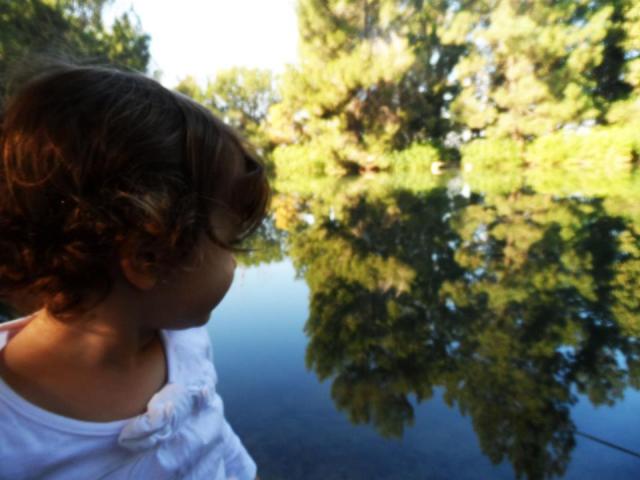 toddler sitting by lake