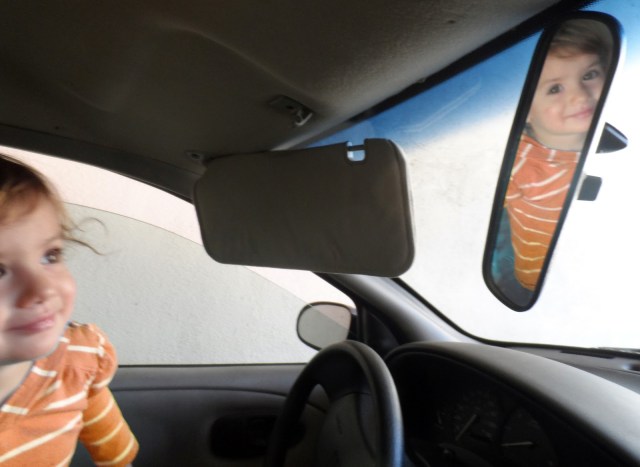 toddler playing in car